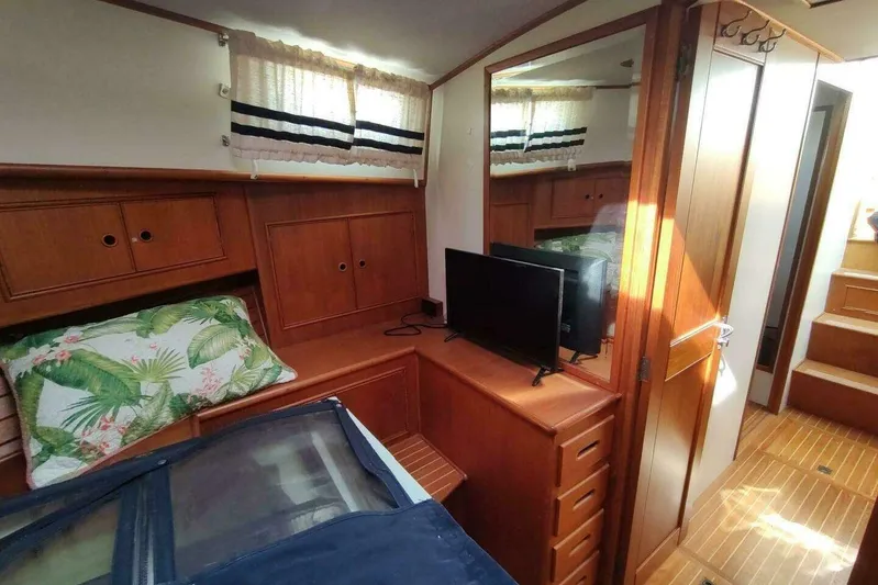 Summersalts Yacht Photos Pics Cozy cabin interior of 1996 Grand Banks Eastbay 40 Flybridge with wood finish and TV.