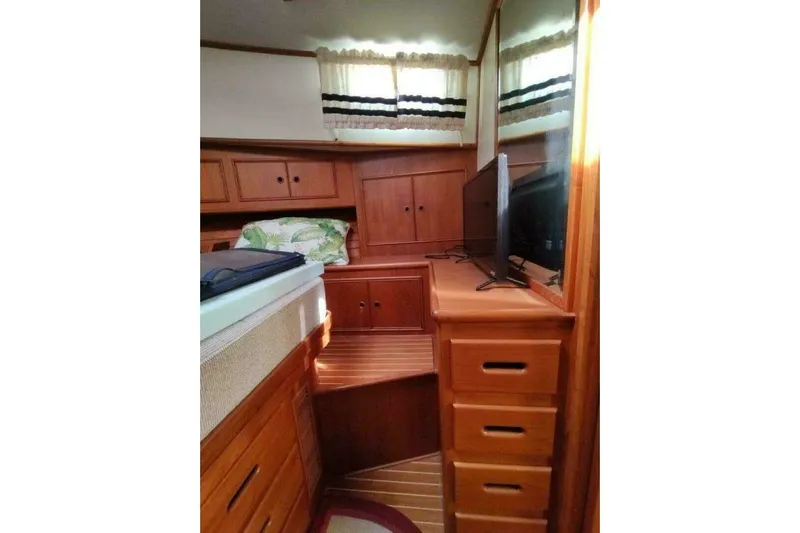 Summersalts Yacht Photos Pics 1996 Grand Banks Eastbay 40 Flybridge cabin with wooden interior and TV.