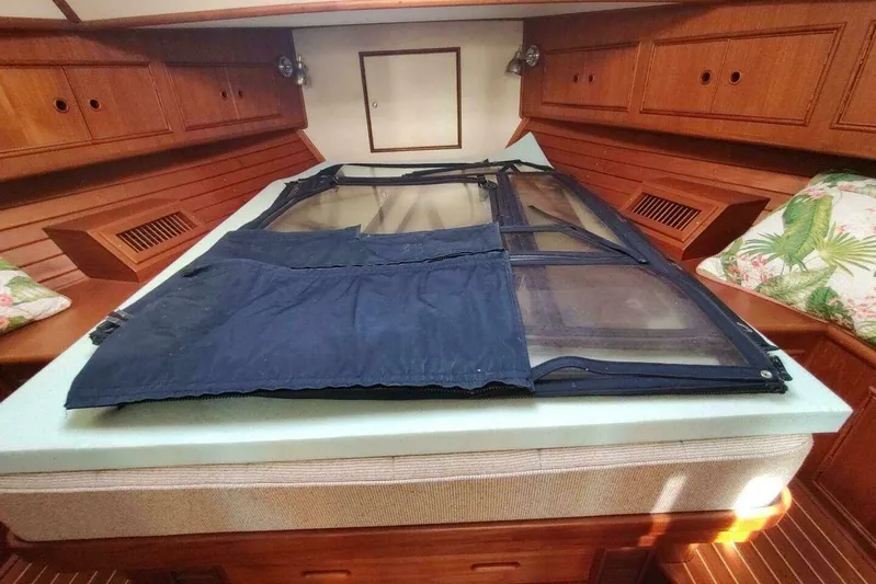 Summersalts Yacht Photos Pics Interior cabin of 1996 Grand Banks Eastbay 40 Flybridge with wooden cabinetry and bedding.
