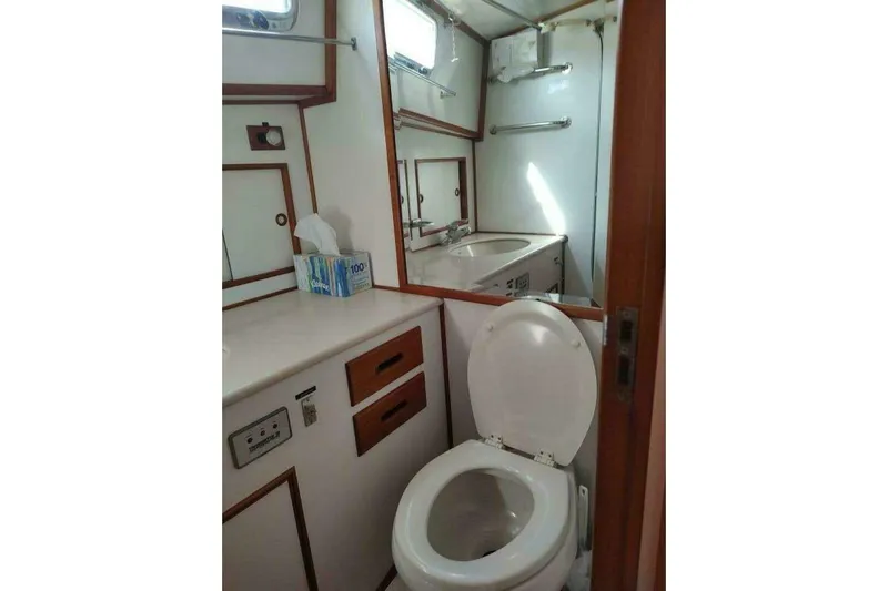 Summersalts Yacht Photos Pics Bathroom interior of 1996 Grand Banks Eastbay 40 Flybridge yacht, featuring toilet and sink.