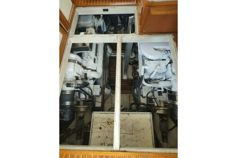 Summersalts Yacht Photos Pics Engine room of 1996 Grand Banks Eastbay 40 Flybridge, showcasing dual engines and mechanical components.