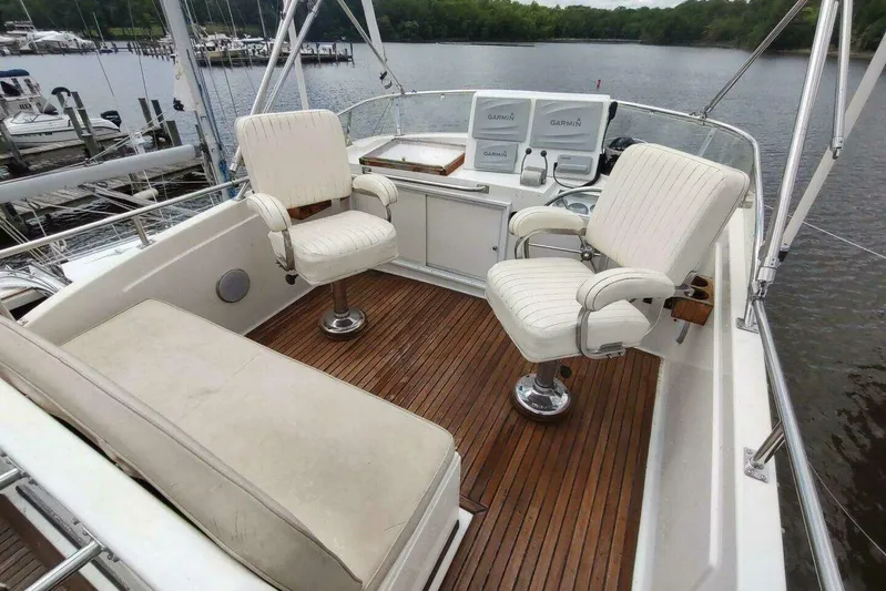 Summersalts Yacht Photos Pics Flybridge of 1996 Grand Banks Eastbay 40 with white seating and wooden deck.