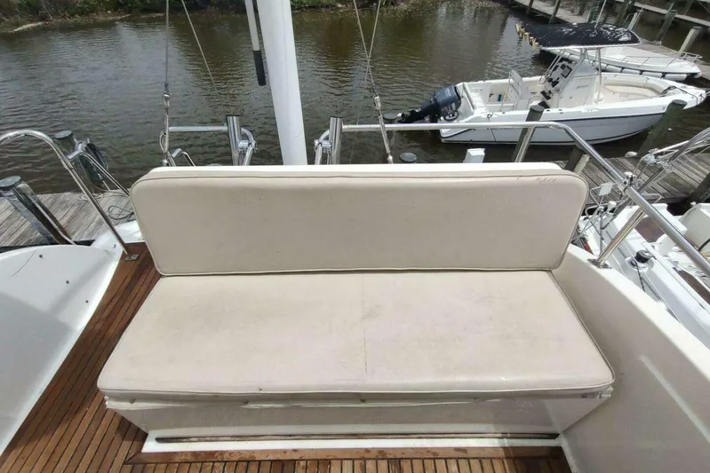 Summersalts Yacht Photos Pics Grand Banks Eastbay 40 Flybridge 1996, featuring a cushioned bench on teak deck.
