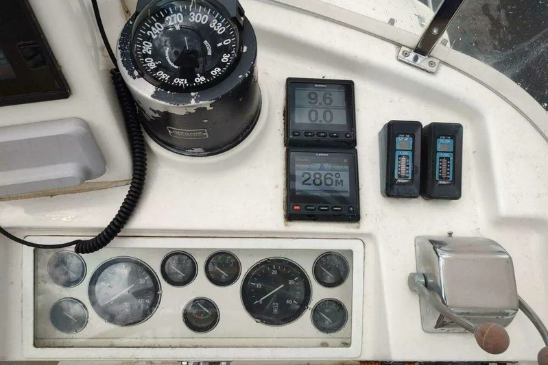 Summersalts Yacht Photos Pics Helm controls of a 1996 Grand Banks Eastbay 40 Flybridge with compass and gauges.