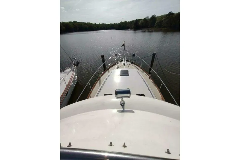 Summersalts Yacht Photos Pics 1996 Grand Banks Eastbay 40 Flybridge on calm river, view from bow.