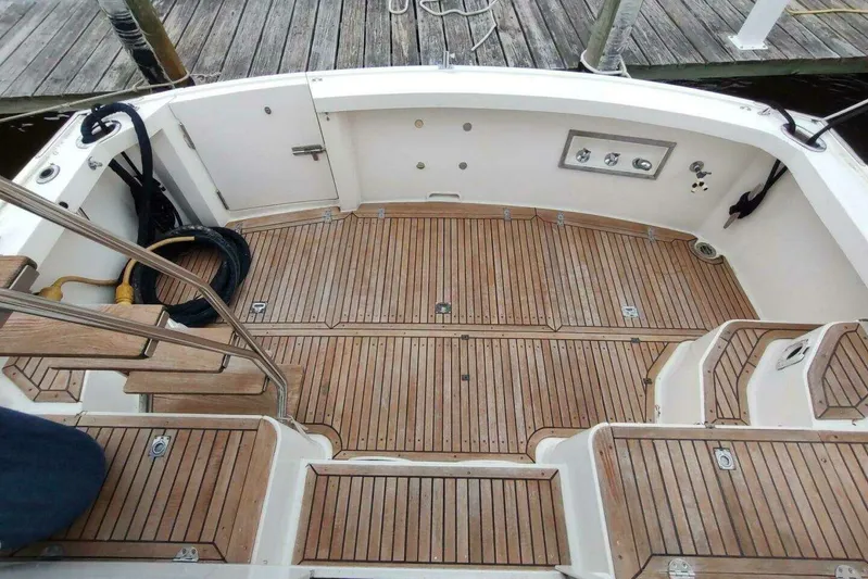Summersalts Yacht Photos Pics 1996 Grand Banks Eastbay 40 Flybridge teak deck with steps and railing, dockside view.