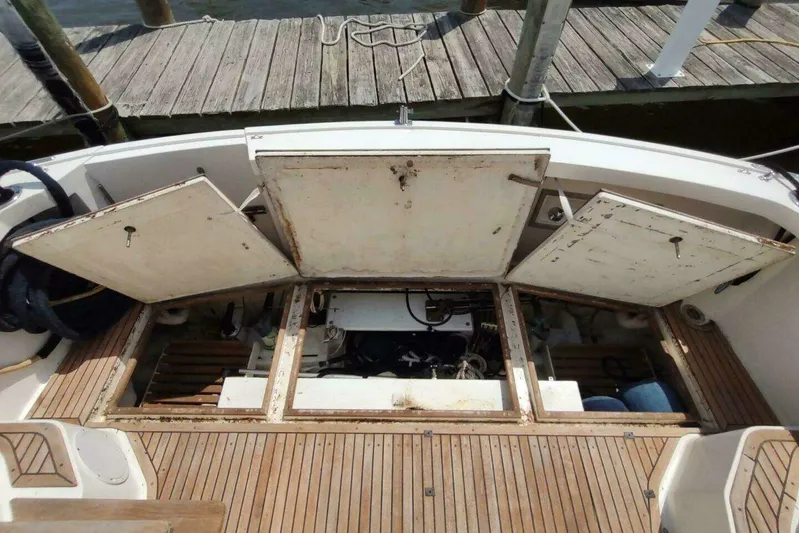 Summersalts Yacht Photos Pics 1996 Grand Banks Eastbay 40 Flybridge engine compartment with open hatches, docked at marina.