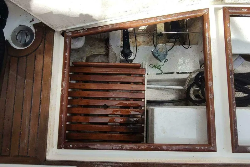 Summersalts Yacht Photos Pics Engine compartment of 1996 Grand Banks Eastbay 40 Flybridge with wooden slats and nautical equipment.