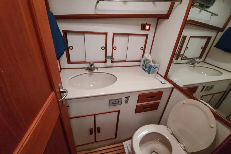 Summersalts Yacht Photos Pics Bathroom interior of 1996 Grand Banks Eastbay 40 Flybridge yacht, featuring sink and toilet.