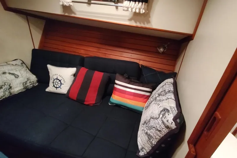 Summersalts Yacht Photos Pics Cozy cabin interior of 1996 Grand Banks Eastbay 40 Flybridge with colorful cushions.