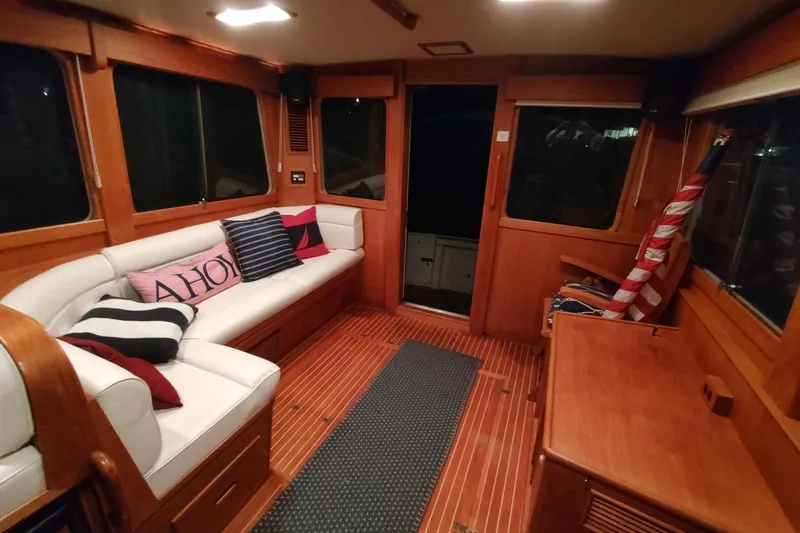 Summersalts Yacht Photos Pics Luxurious 1996 Grand Banks Eastbay 40 Flybridge interior with cozy seating and nautical decor.