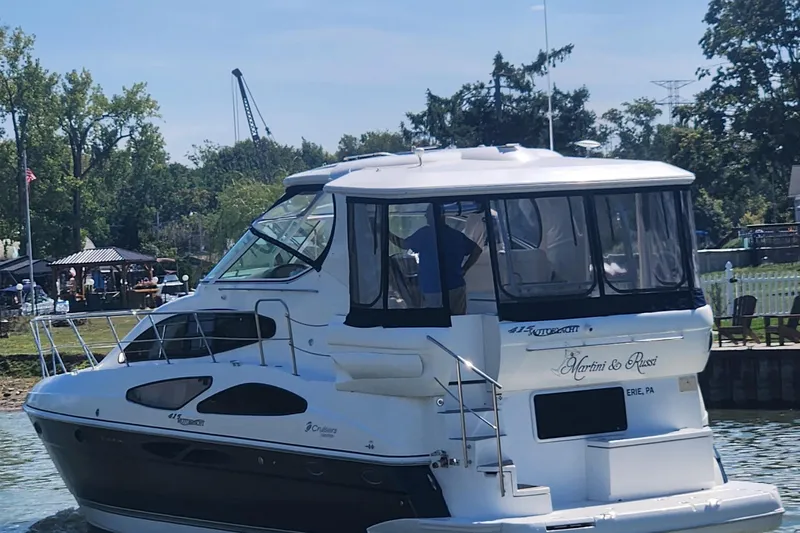  Yacht Photos Pics 2008 CRUISERS INC 415 Express Motoryacht docked near a scenic waterfront.