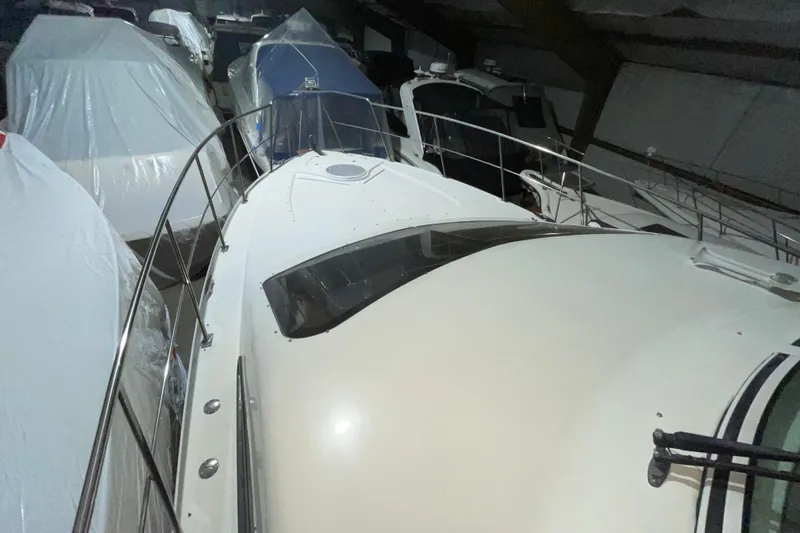  Yacht Photos Pics 2008 CRUISERS INC 415 Express Motoryacht in storage, surrounded by covered boats.