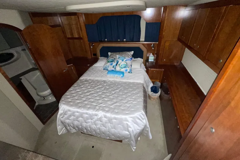  Yacht Photos Pics Luxurious bedroom in 2008 CRUISERS INC 415 Express Motoryacht with elegant wood cabinetry.