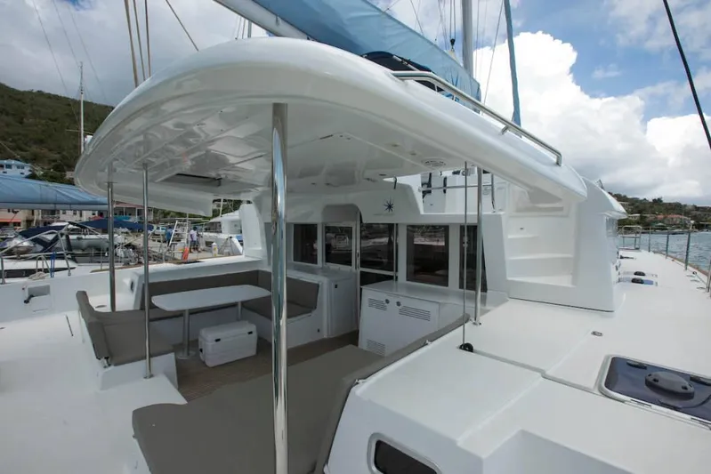  Yacht Photos Pics 2018 Lagoon 450 F catamaran with spacious deck and seating area in marina setting.