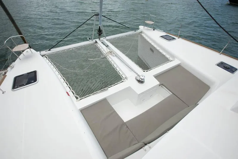  Yacht Photos Pics 2018 Lagoon 450 F catamaran deck with netting and cushioned seating.
