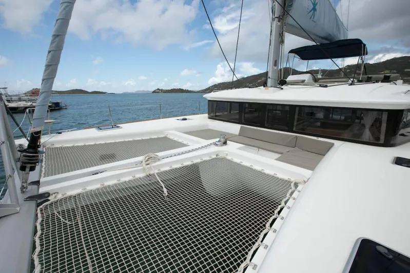  Yacht Photos Pics 2018 Lagoon 450 F catamaran with spacious deck and netting, anchored in scenic waters.