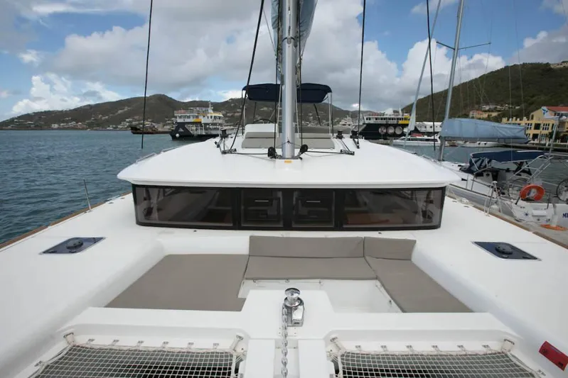  Yacht Photos Pics 2018 Lagoon 450 F catamaran docked, featuring spacious deck and scenic harbor view.