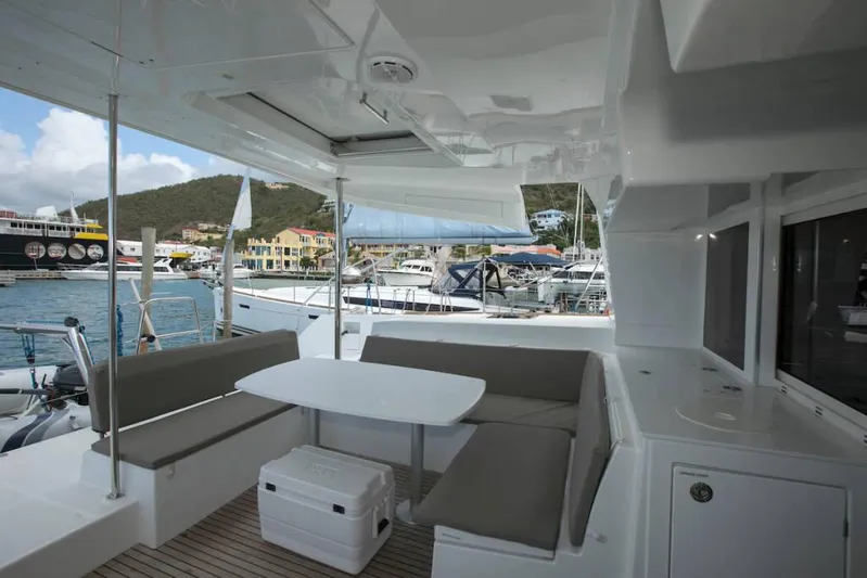  Yacht Photos Pics 2018 Lagoon 450 F catamaran with outdoor seating, docked at marina.
