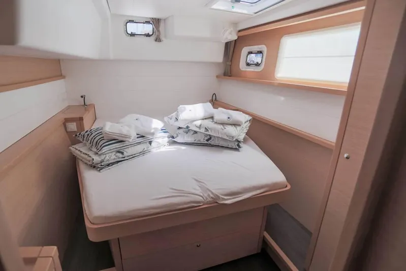  Yacht Photos Pics Cozy cabin interior of 2018 Lagoon 450 F catamaran with neatly arranged bedding.