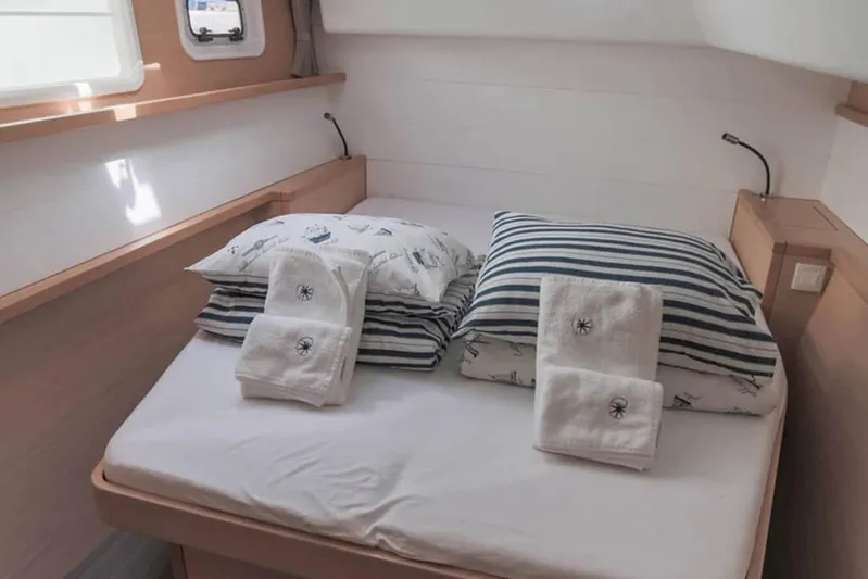  Yacht Photos Pics Cozy cabin interior of 2018 Lagoon 450 F with neatly arranged bed and towels.