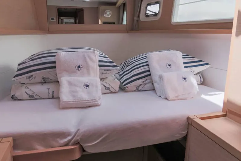  Yacht Photos Pics Interior cabin of 2018 Lagoon 450 F yacht with neatly arranged bedding and towels.