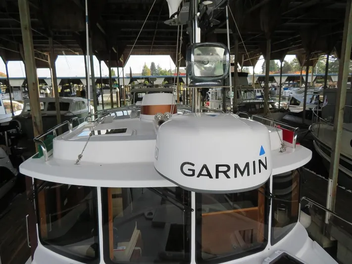 Then Again Yacht Photos Pics 2018 Ranger Tugs R-31 S boat with Garmin equipment in a covered marina.