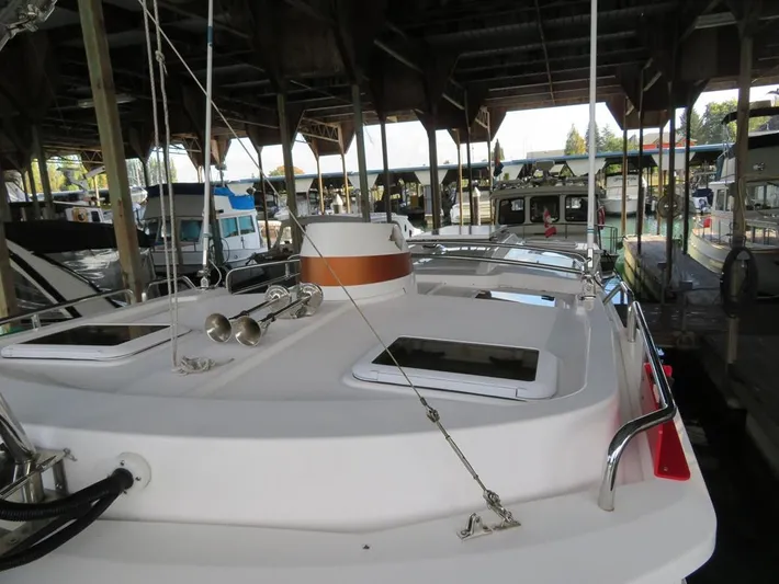 Then Again Yacht Photos Pics 2018 Ranger Tugs R-31 S boat docked in a covered marina.