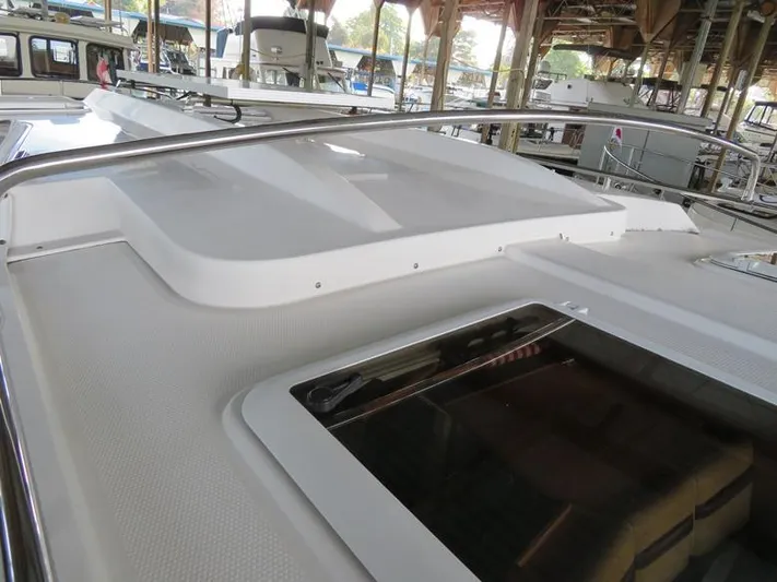 Then Again Yacht Photos Pics 2018 Ranger Tugs R-31 S boat deck with railing and hatch in marina setting.