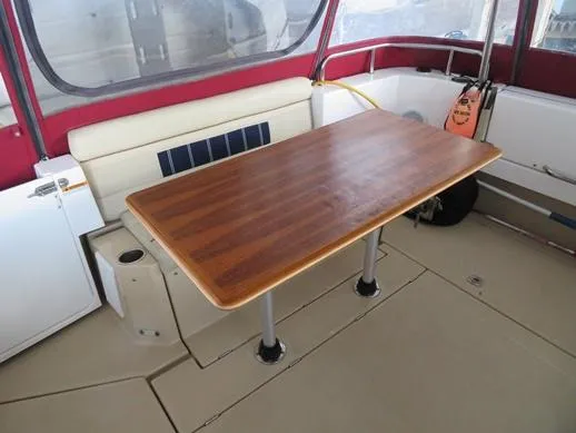 Then Again Yacht Photos Pics 2018 Ranger Tugs R-31 S interior with wooden table and seating area.