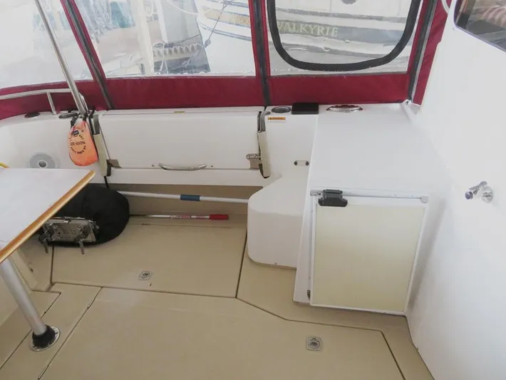 Then Again Yacht Photos Pics 2018 Ranger Tugs R-31 S interior with seating, storage, and red canopy.
