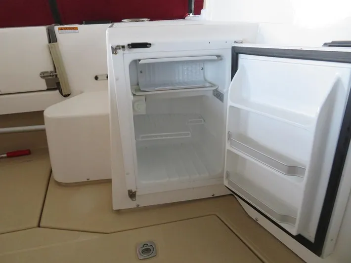 Then Again Yacht Photos Pics Open mini fridge on 2018 Ranger Tugs R-31 S boat, showing interior shelves.