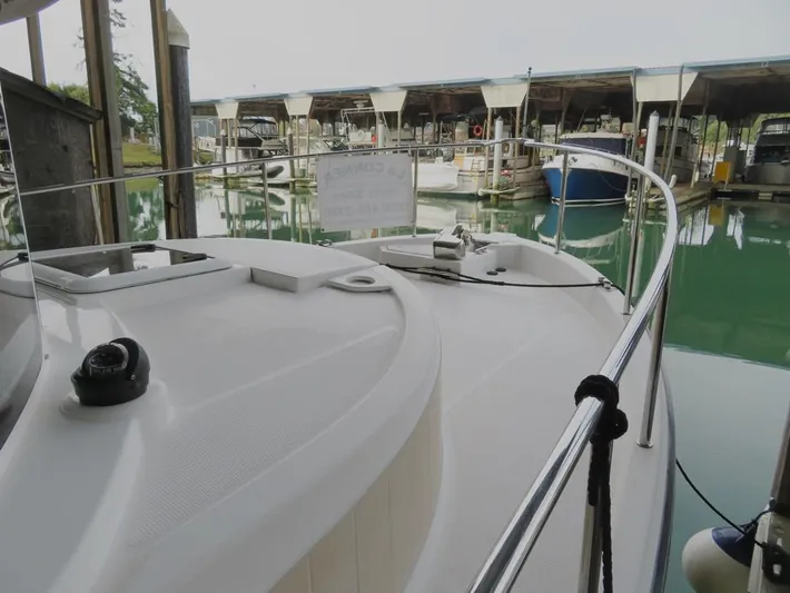 Then Again Yacht Photos Pics 2018 Ranger Tugs R-31 S docked in a marina with covered slips.