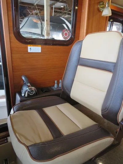 Then Again Yacht Photos Pics Captain's chair in 2018 Ranger Tugs R-31 S boat, featuring leather upholstery and wooden interior.