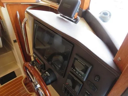 Then Again Yacht Photos Pics 2018 Ranger Tugs R-31 S helm with navigation equipment and wooden steering wheel.