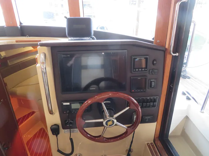 Then Again Yacht Photos Pics 2018 Ranger Tugs R-31 S helm with steering wheel and navigation controls.