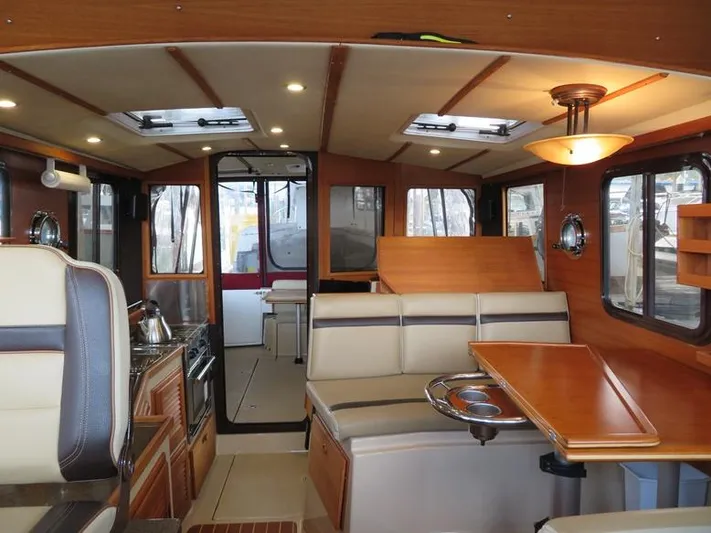 Then Again Yacht Photos Pics Interior of 2018 Ranger Tugs R-31 S, featuring seating, table, and kitchen area.