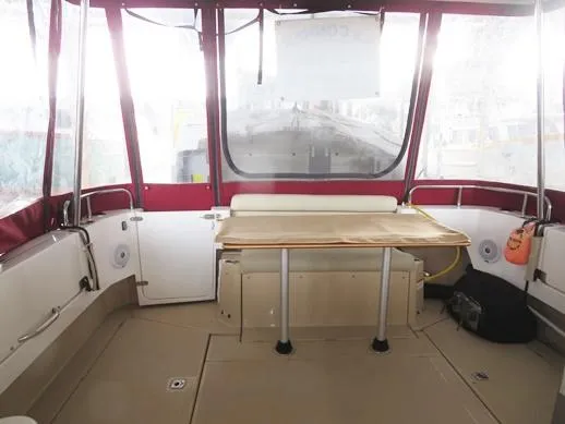 Then Again Yacht Photos Pics 2018 Ranger Tugs R-31 S interior with table, red canopy, and spacious seating area.