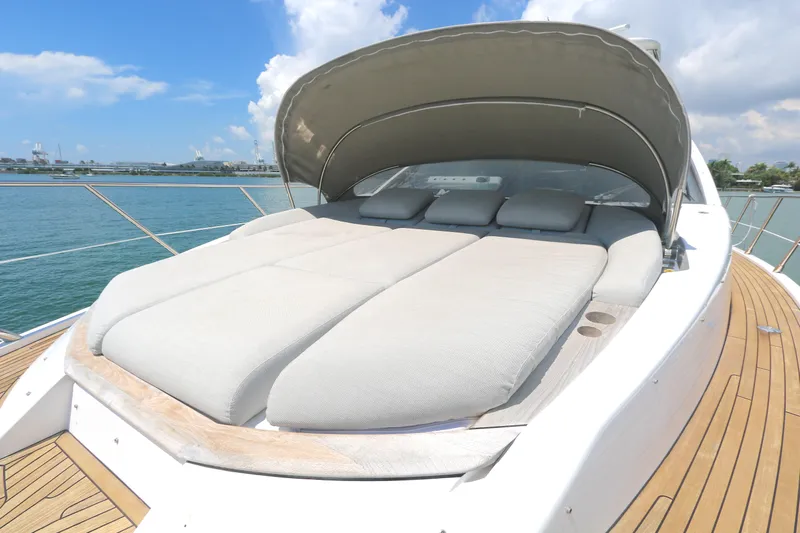 Bon Bon Yacht Photos Pics Luxurious sunbed on 2020 Azimut 55 yacht, featuring sleek design and ocean backdrop.