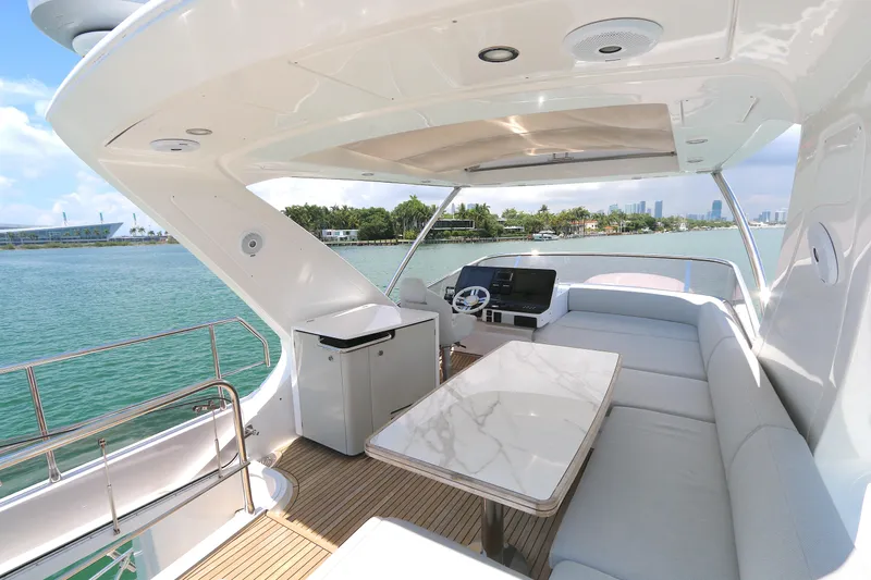 Bon Bon Yacht Photos Pics Luxurious 2020 Azimut 55 yacht interior with elegant seating and scenic ocean view.