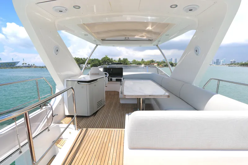 Bon Bon Yacht Photos Pics Luxurious 2020 Azimut 55 yacht deck with seating, table, and ocean view.