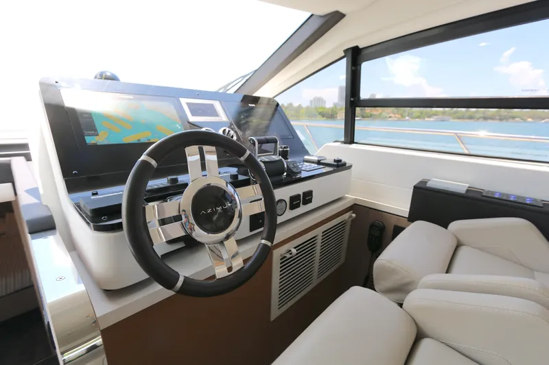 Bon Bon Yacht Photos Pics Luxurious Azimut 55 yacht helm with modern controls and scenic ocean view, 2020 model.