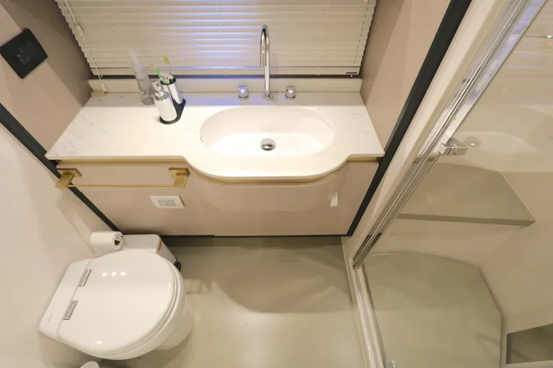 Bon Bon Yacht Photos Pics Luxurious bathroom in 2020 Azimut 55 yacht with modern fixtures and shower.