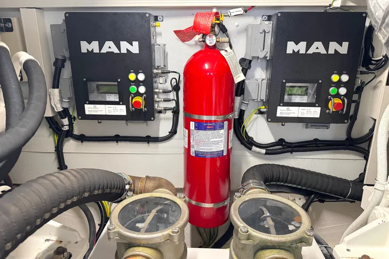 Bon Bon Yacht Photos Pics Engine room of 2020 Azimut 55 yacht with MAN control panels and fire extinguisher.