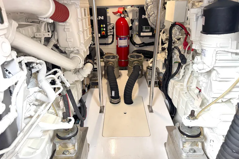 Bon Bon Yacht Photos Pics Engine room of a 2020 Azimut 55 yacht, featuring mechanical components and fire extinguisher.
