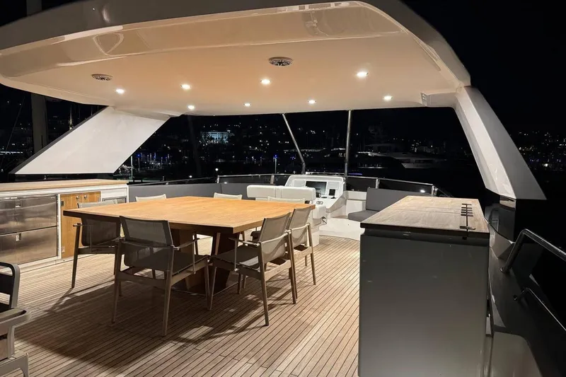 Maoria Yacht Photos Pics Luxurious 2021 Numarine 26XP yacht deck with elegant dining area at night.