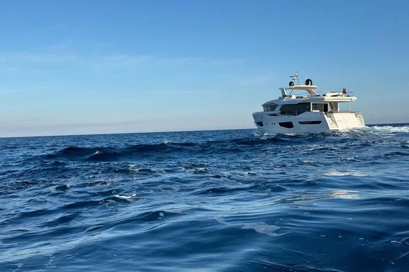 Maoria Yacht Photos Pics Luxurious 2021 Numarine 26XP yacht cruising on open sea under clear blue sky.