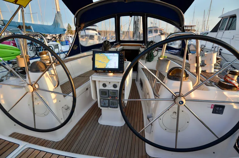 Footloose Yacht Photos Pics Cockpit of 2003 Bavaria 49 sailboat with dual steering wheels and navigation equipment.