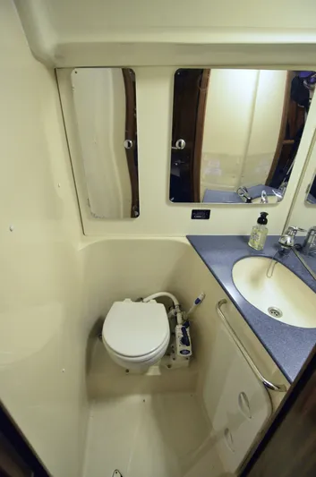 Footloose Yacht Photos Pics 2003 Bavaria 49 yacht bathroom with toilet, sink, and mirror.