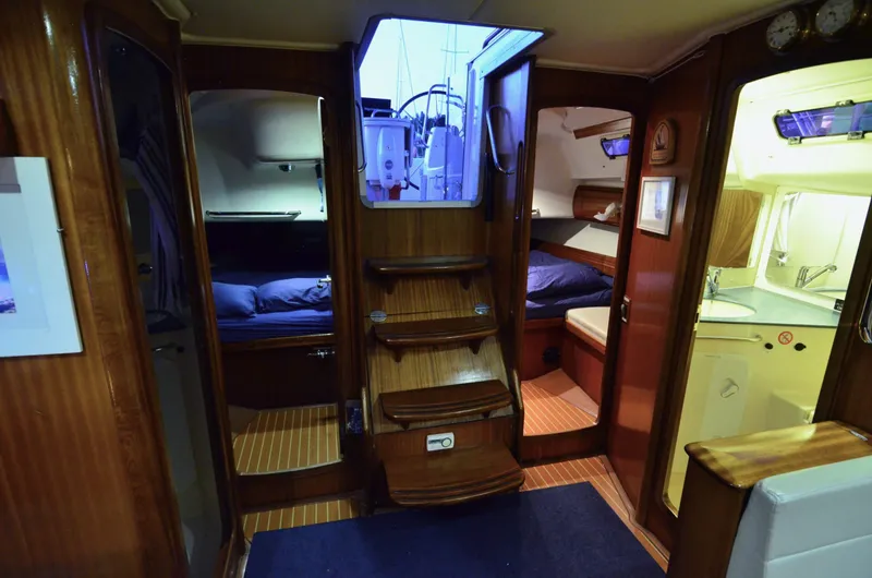 Footloose Yacht Photos Pics Interior of a 2003 Bavaria 49 yacht, featuring cozy cabins and a compact kitchen area.